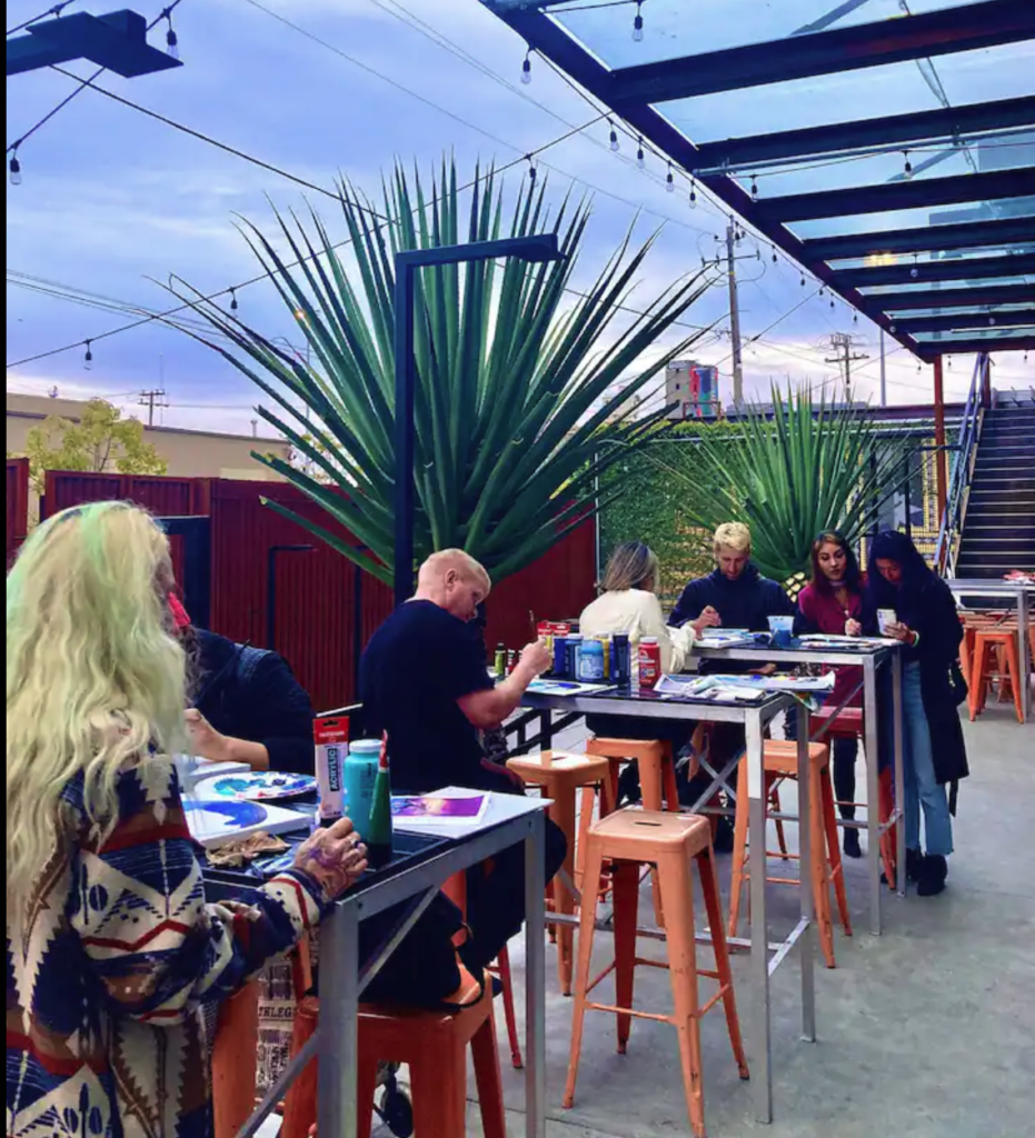 Team members sipping wine and painting during a creative team building activity in San Francisco’s Upper Nob Hill.