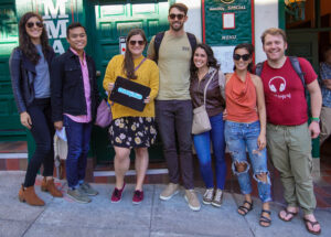 People posing in front of a restaurant after a food tour in San Francisco. 