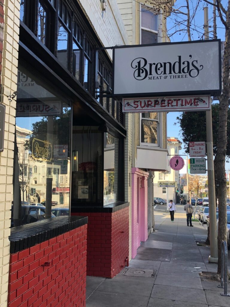 Storefront of Brenda’s Meat & Three, a southern-inspired eatery near the Painted Ladies, offering hearty brunch favorites like Johnny Cakes and beignets.