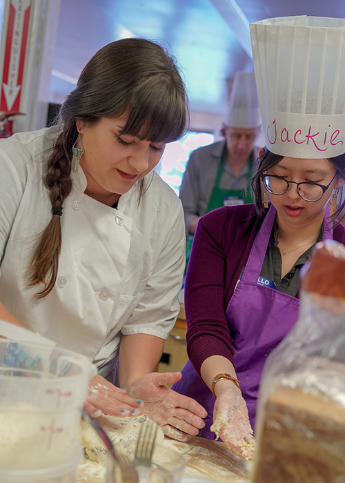 A couple cooking together in a Valentine's Day-themed cooking class in the Bay Area.