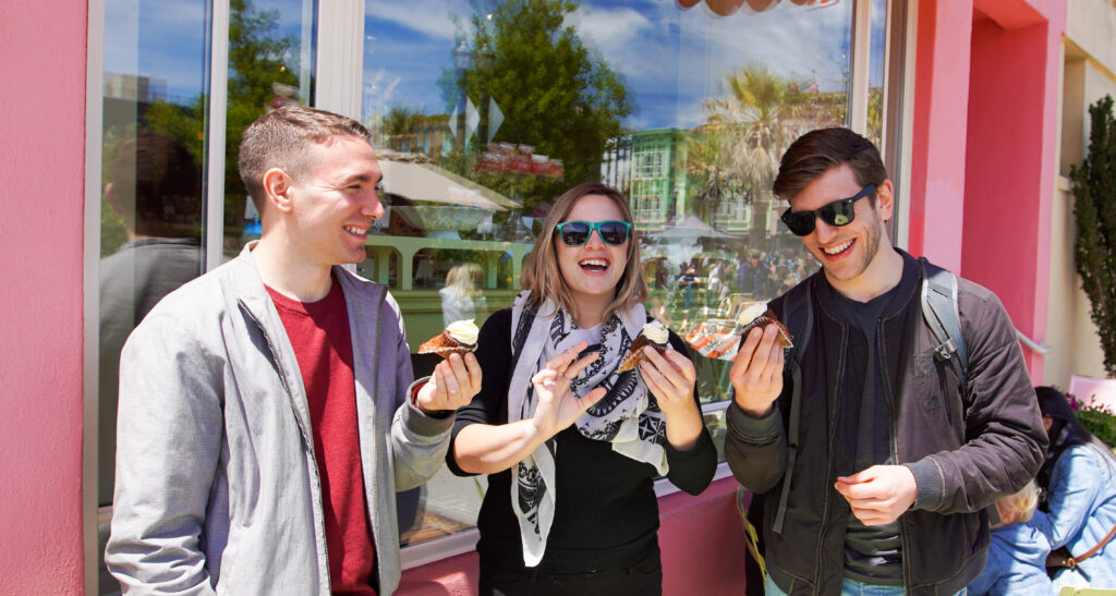 Three people tasting ice cream on a food tour in San Francisco. 