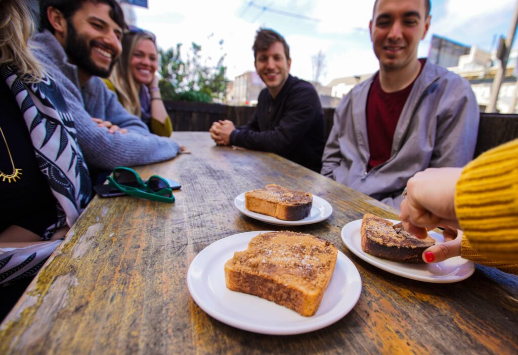 People enjoying San Francisco sourdough French toast at The Mill, a cozy café near Alamo Square known for its artisanal breads, toast varieties, and Four Barrel coffee.