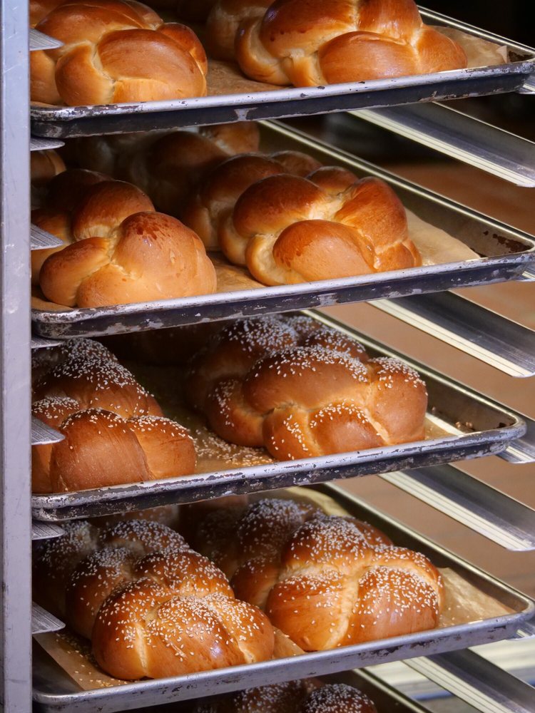 Trays of freshly baked San Francisco sourdough loaves at Noe Valley Bakery, a beloved family-owned shop serving the community with artisanal breads since 1995.