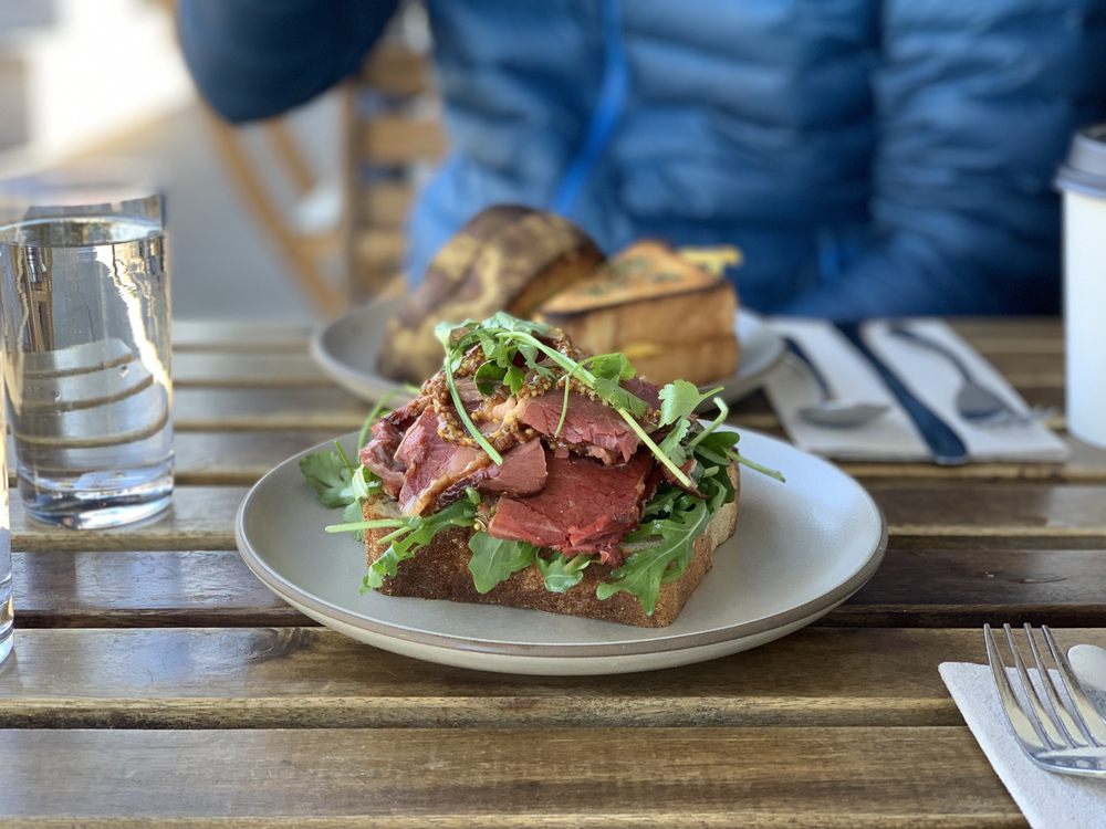 Close-up of a hearty sandwich made with Outerlands' signature San Francisco sourdough, filled with fresh ingredients, showcasing their artisanal baking expertise in the Outer Sunset neighborhood.