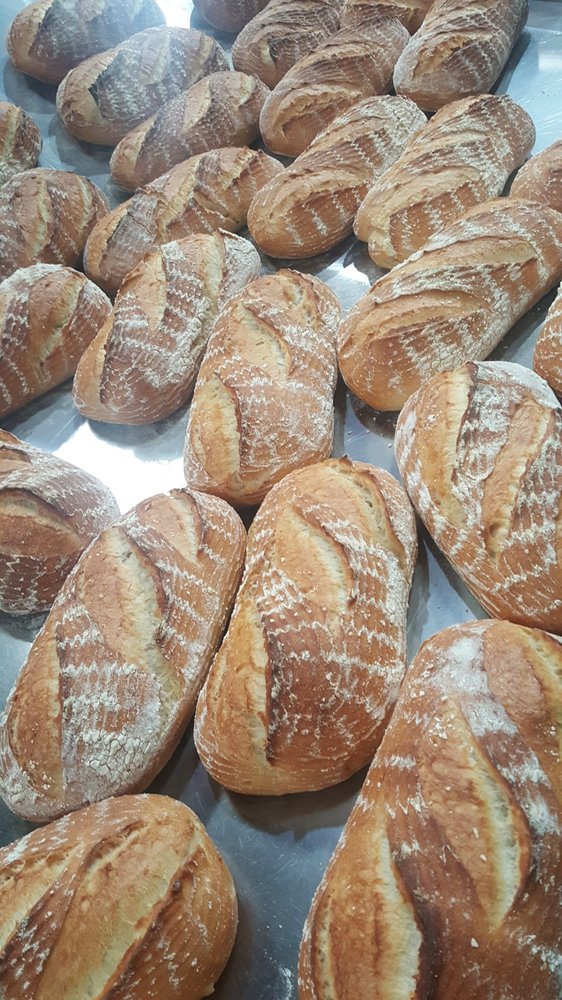 Close-up of multiple freshly baked San Francisco sourdough bread loaves, showcasing the artisanal quality at Woodhouse Fish Co.