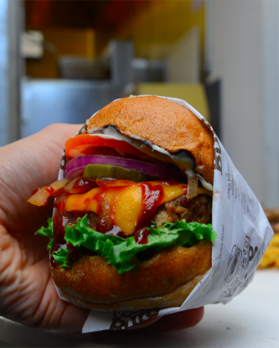 A stacked vegan burger from VeganBurg, one of the must-visit vegan restaurants San Francisco offers, known for its creative plant-based burger options.