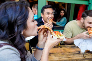 People eating pizza on a private San Francisco food tour with Stretchy Pants. 